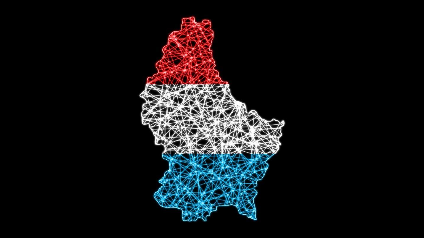 Red, white, and blue crisscrossing lines illuminate a map of Luxembourg in a section about the country’s tax advantages.