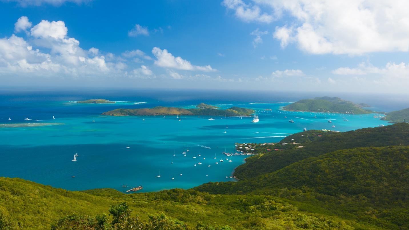 Forested islands surrounded by the sea and boats in a section about tax policy in the British Virgin Islands.