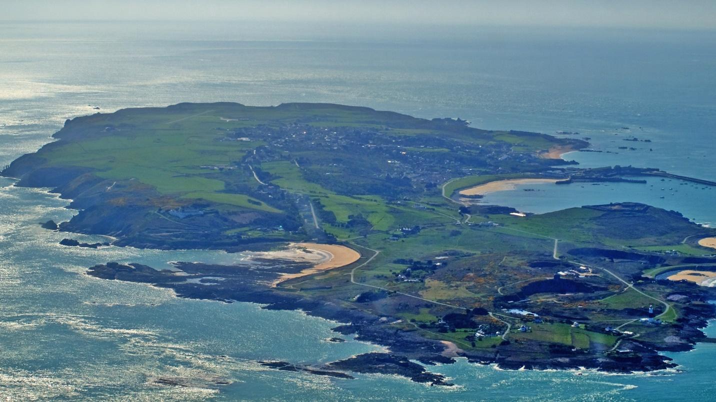 A green island surrounded by blue sea in a section about the tax policies of the Channel Islands.