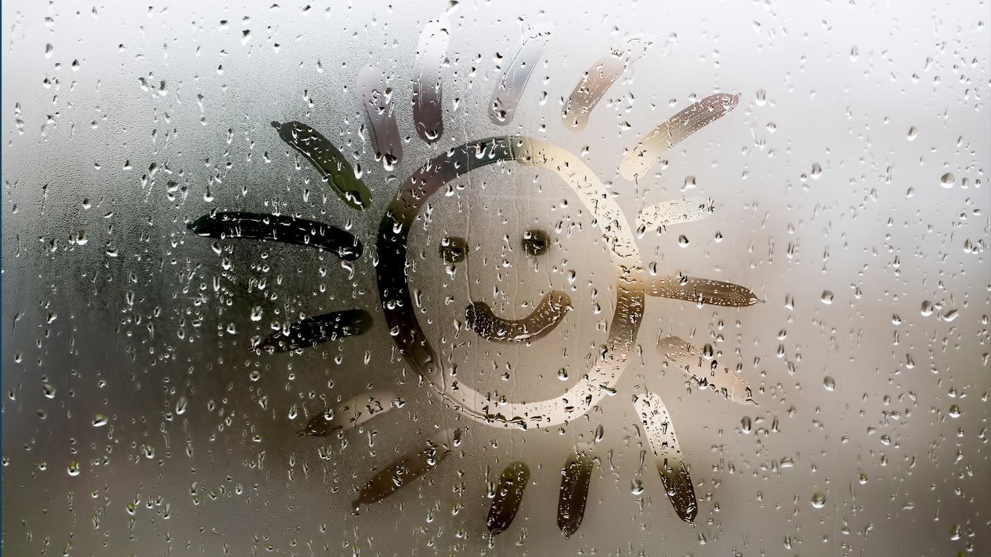 A sun with a smiley face drawn into the condensation on a glass pane in a section about staying safe after a storm in Puerto Rico.