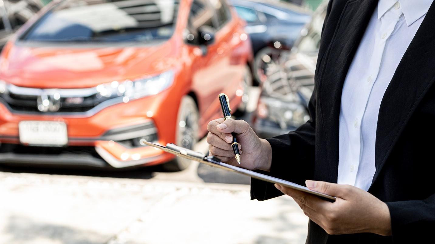 agent filling out forms in a car dealership