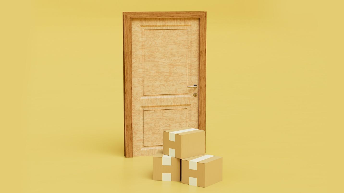 Three cardboard boxes in front of a closed door in a section explaining address information in Puerto Rico.