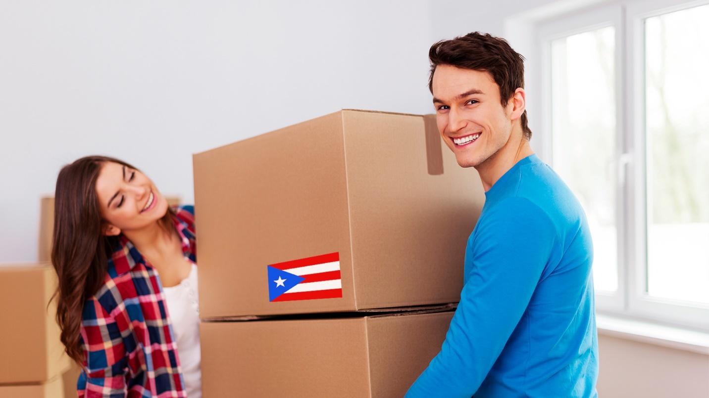 A smiling man and woman carry cardboard boxes in a section that explains how PRelocate can make a move to Puerto Rico easy.
