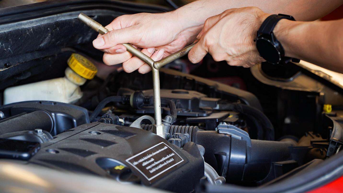 car technician repairing a car's engine
