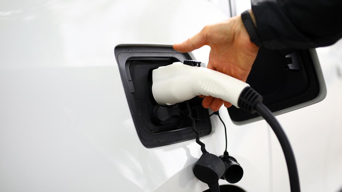 man charging a Tesla car