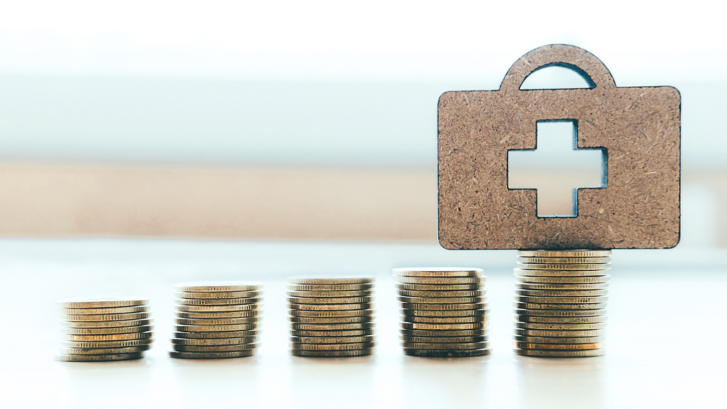 Stacks of coins and an icon of a briefcase with a medical cross in a section about federal funding to Puerto Rico’s Medicaid program.
