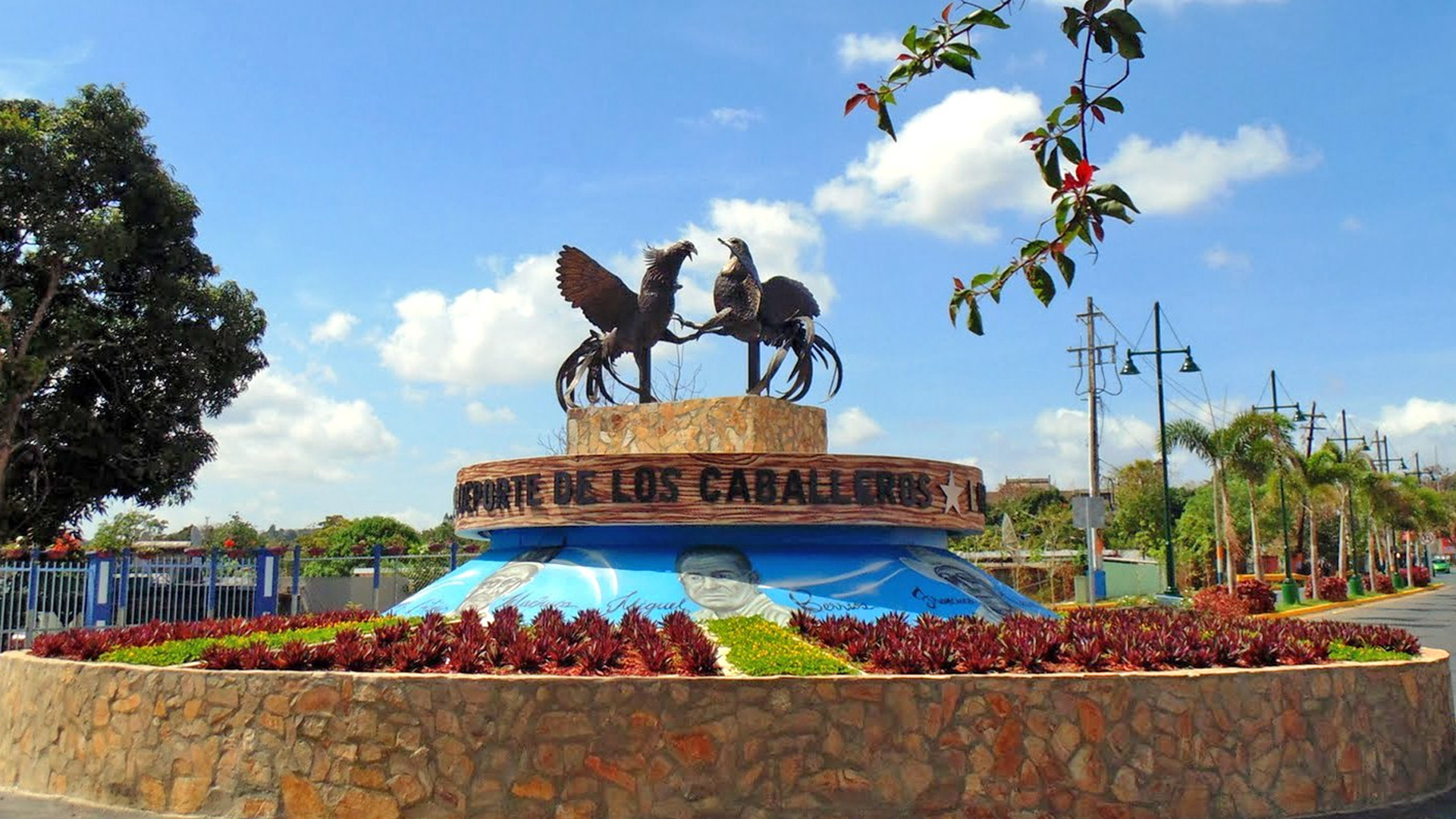 Monument with statues of chickens at a roundabout in Guaynabo, Puerto Rico.