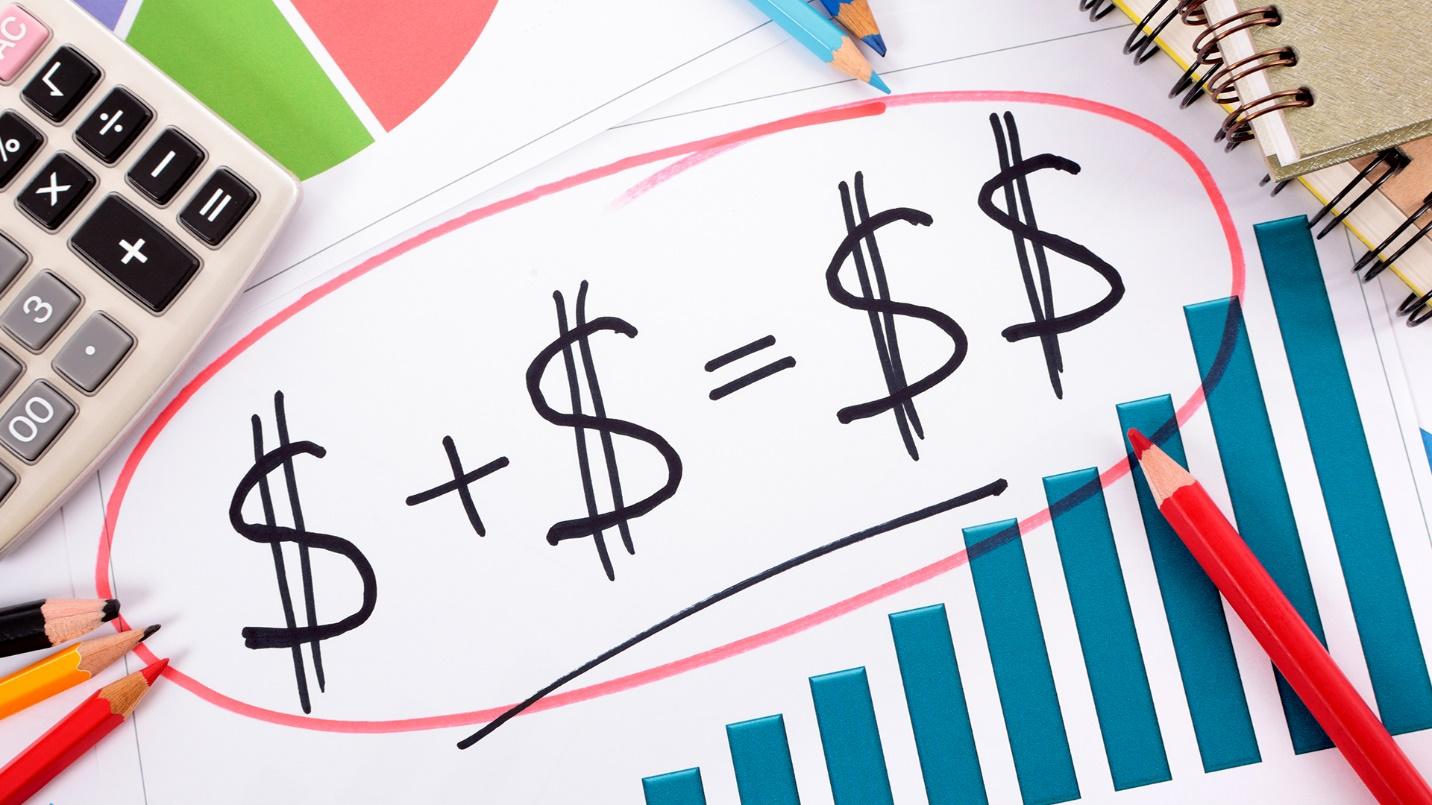 Dollar signs circled in red, surrounded by notebooks, graphs, pencils, and a calculator, in a section about the economic and tax benefits of moving to Puerto Rico.