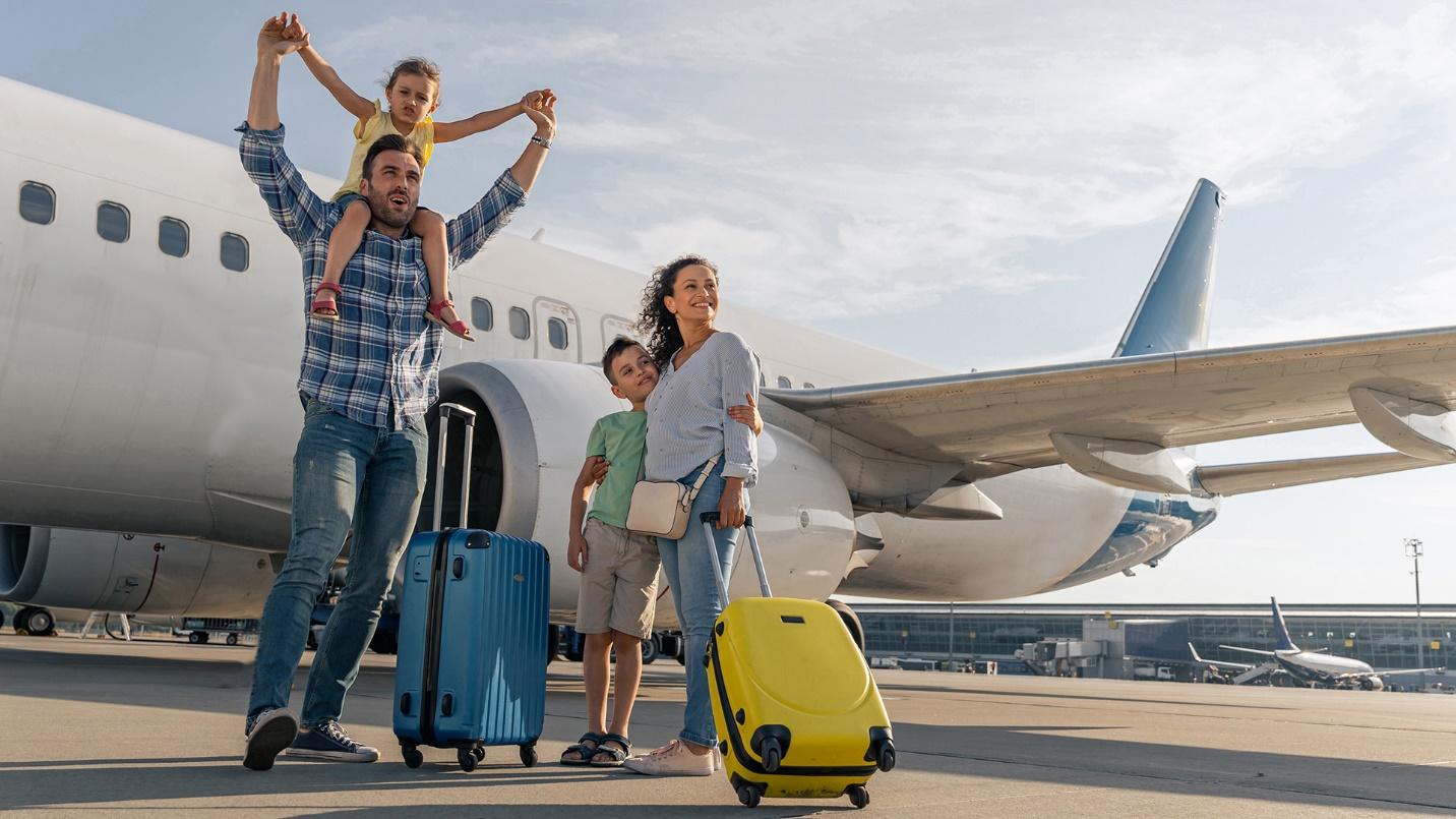 A family of four stands by suitcases and an airplane in a section about how PRelocate can help new residents of Puerto Rico.