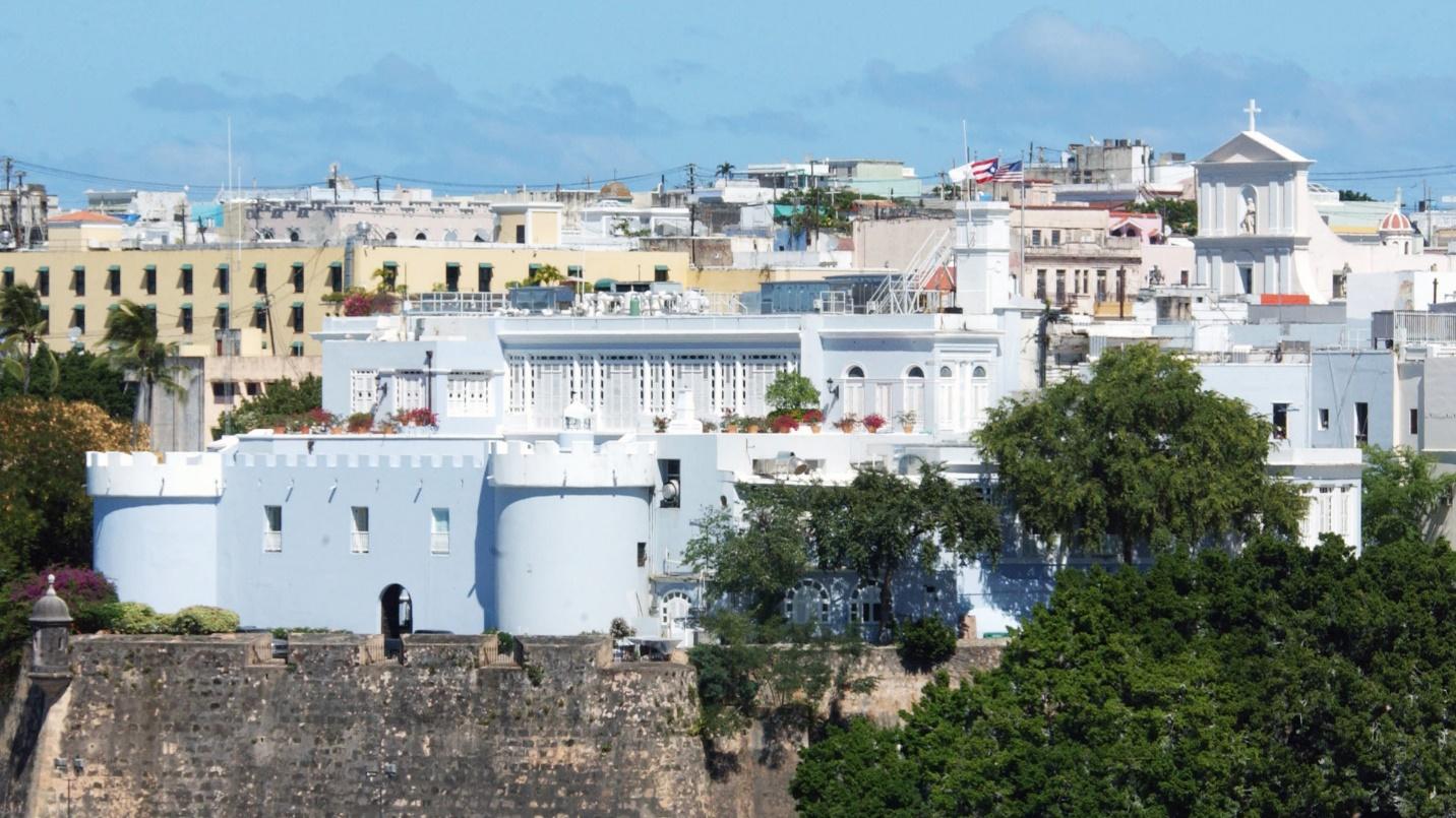 The white walls of La Fortaleza in a section about its history, mansion, offices, and what a visitor can see on a tour.