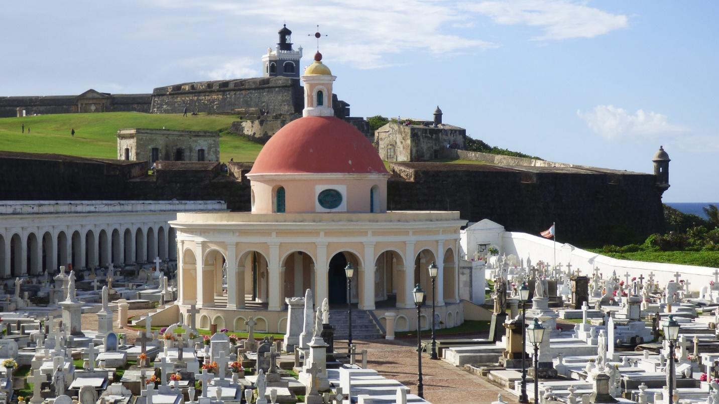 A red-domed chapel surrounded by gravestones near a Spanish fort in a section about Santa Maria Magdalena de Pazzis Cemetery.