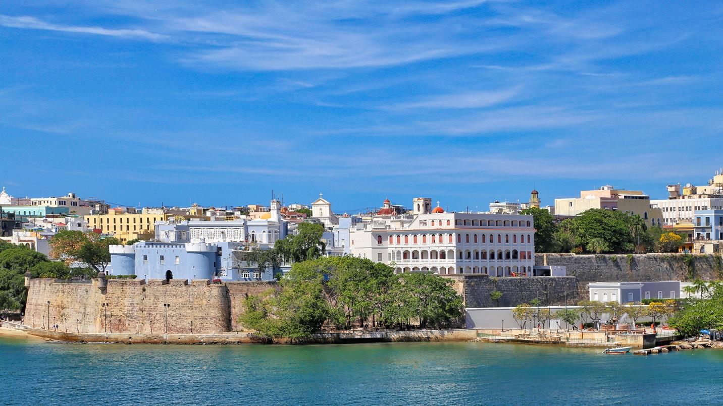 The old city walls of Puerto Rico separate housing and government buildings from the sea.