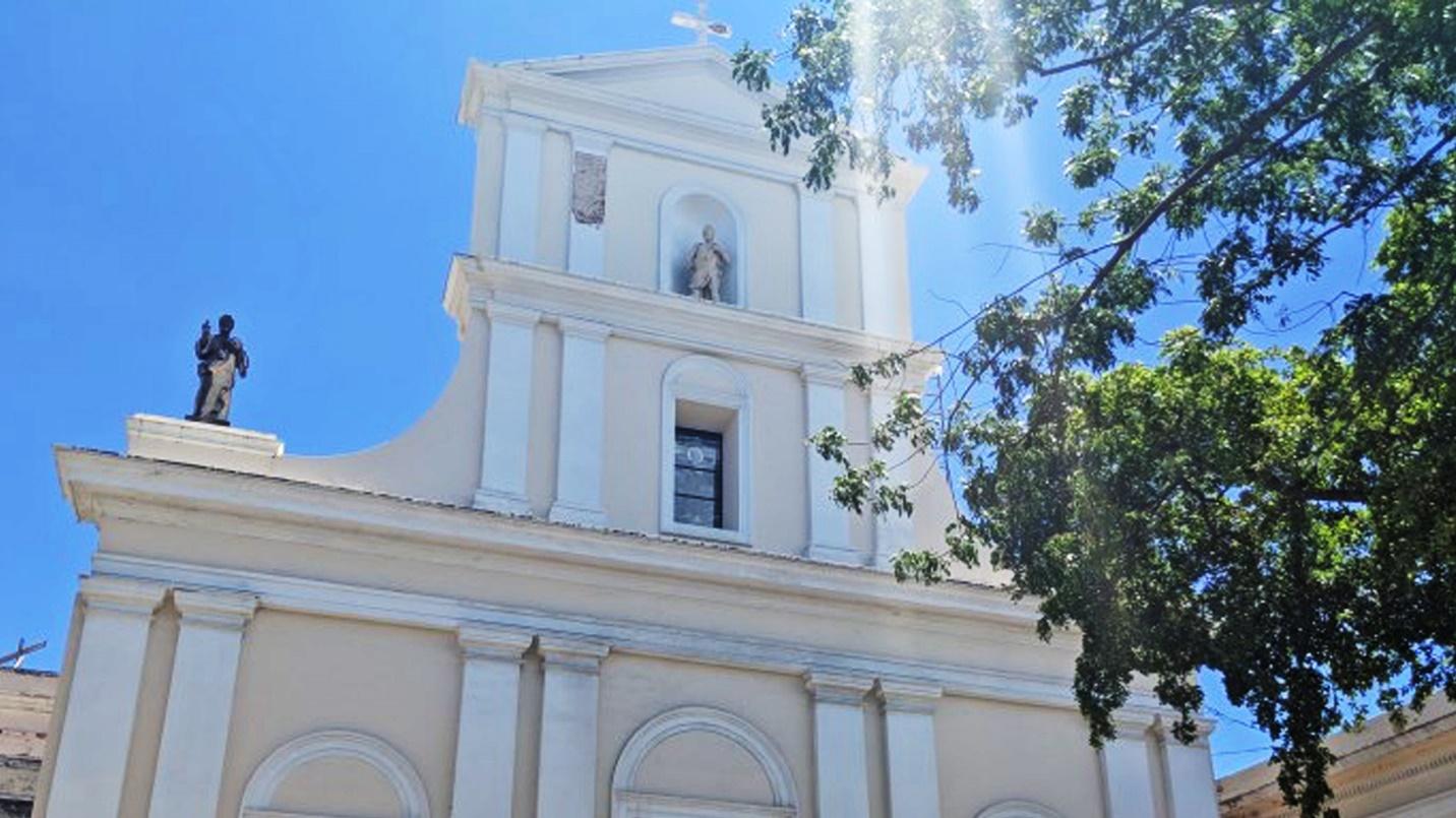 The white and beige façade of San Juan Cathedral, the oldest cathedral in the United States, in Old San Juan.