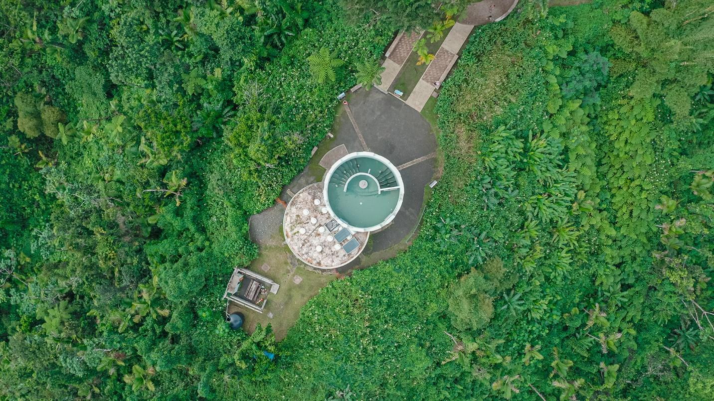 Facilities at El Yunque National Forest surrounded by vegetation in a section about what to see and do in this tropical rainforest.