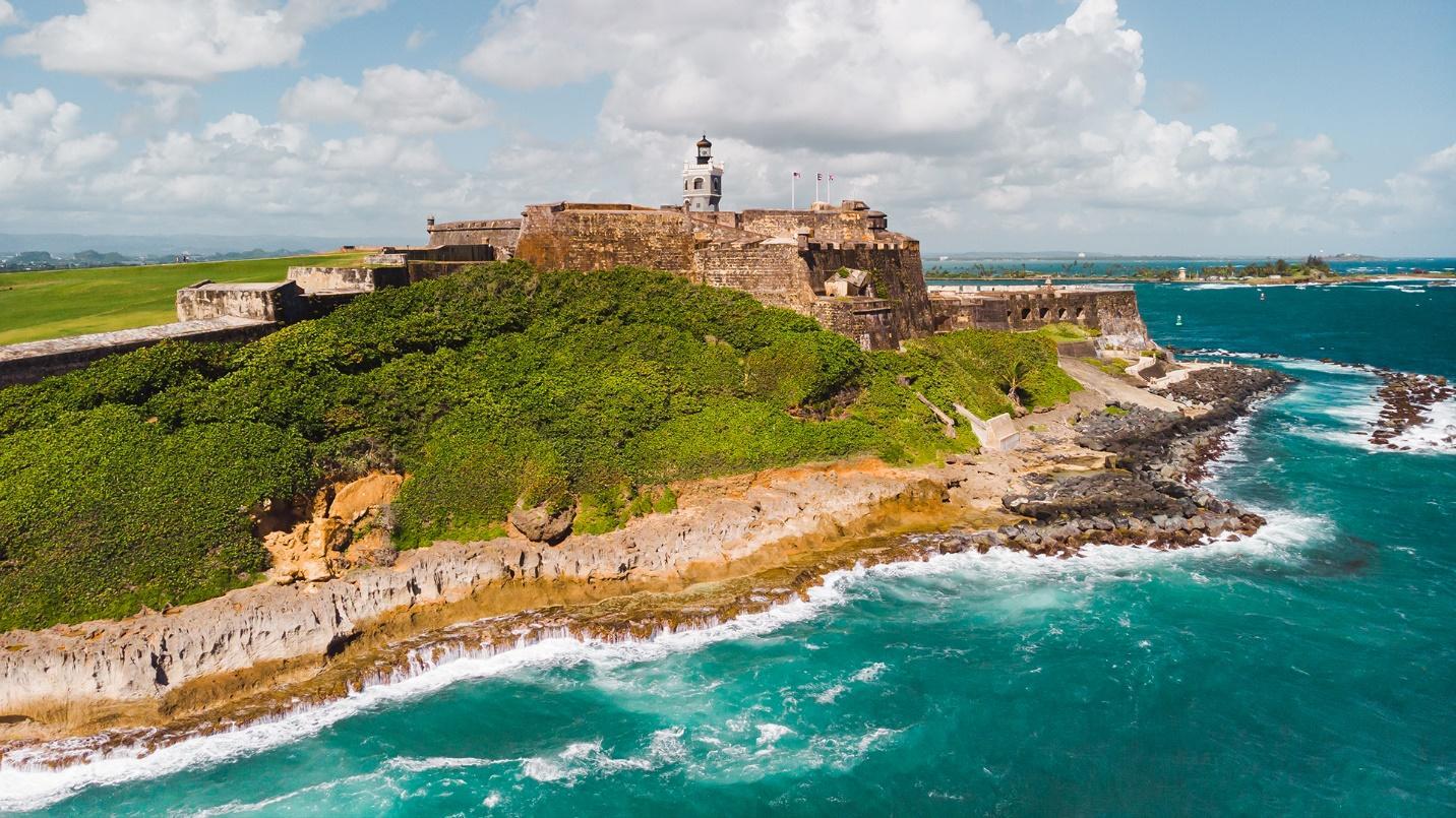 Waves crash against the cliffs and shoreline by El Morro in a section about this historic Spanish fort in Old San Juan. 