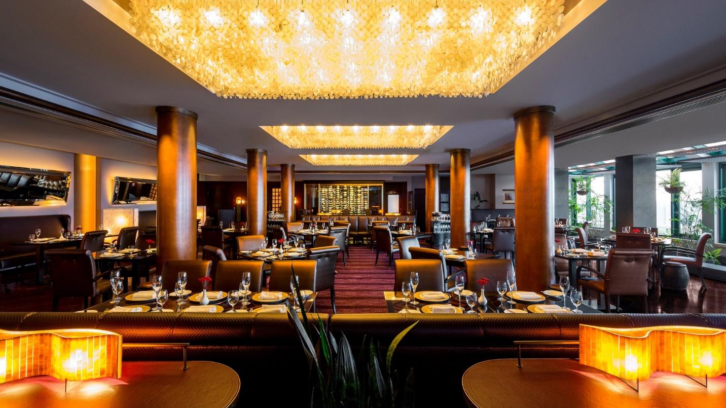 A posh dining room with set tables in a section about fine dining in the neighborhood. 