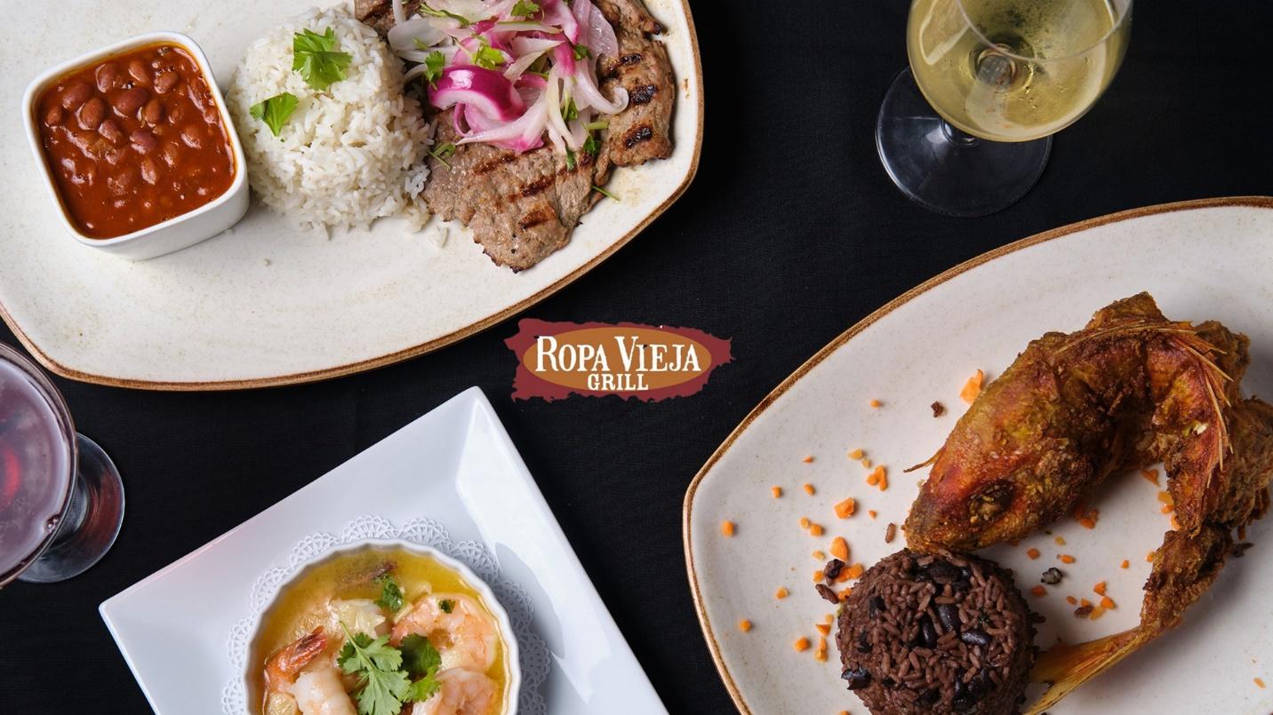 Plates of rice, beans, steak, fish, and shrimp in a section about Ropa Vieja Grill. 