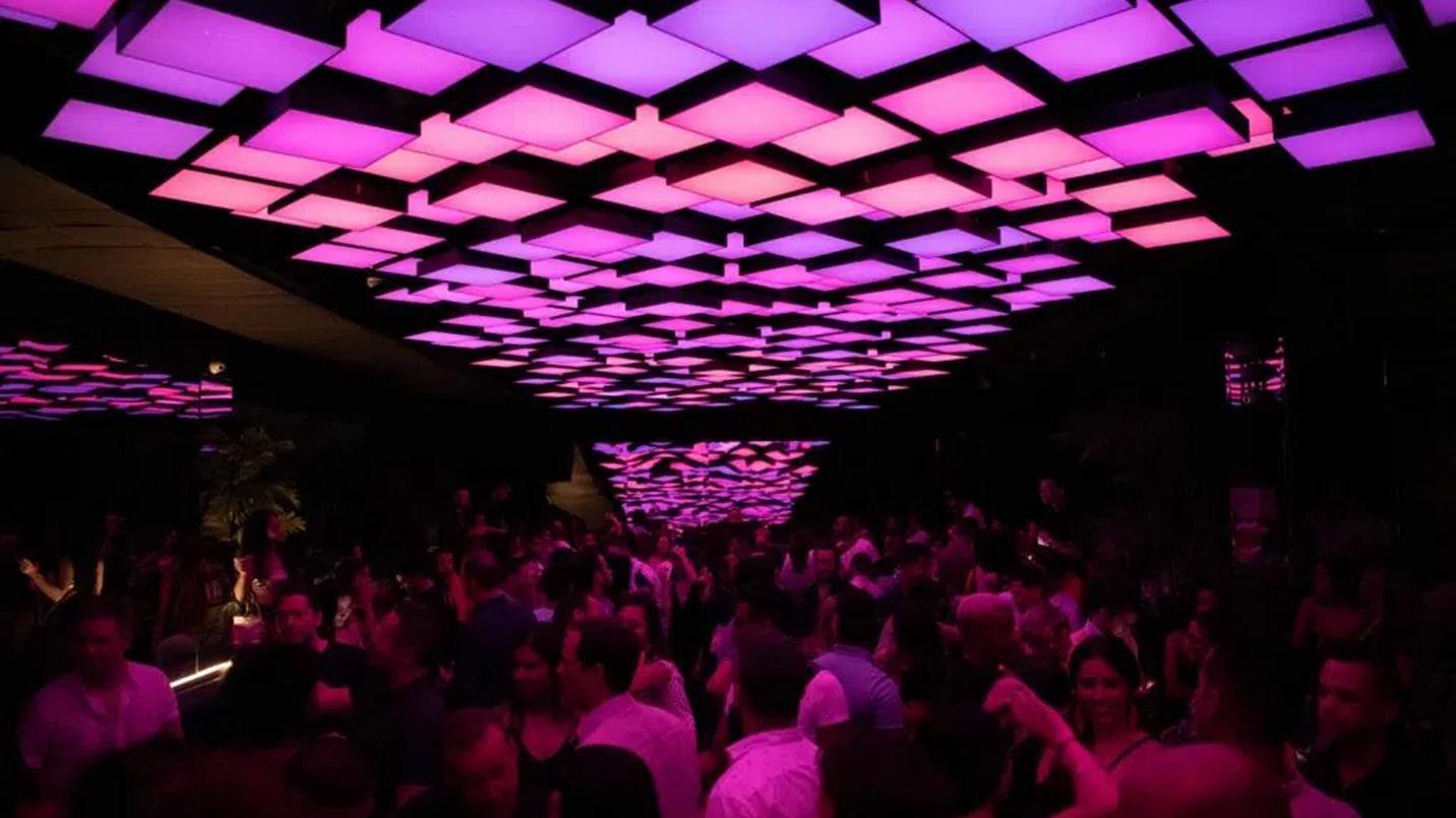 Fifty Eight Nightclub bathed in dim, purple light in a section about Condado’s nightlife and entertainment. 