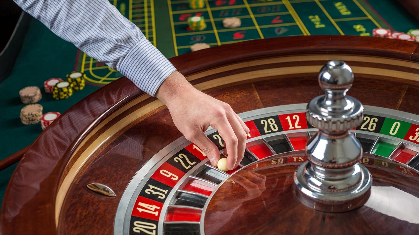 A dealer holds the ball at a roulette wheel in a section about the neighborhood’s casinos. 