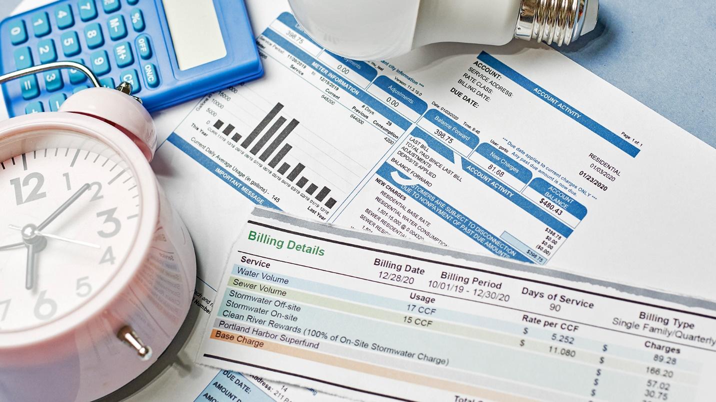 Bills, an alarm clock, calculator, and lightbulb in a section about the availability and cost of utilities in Puerto Rico.
