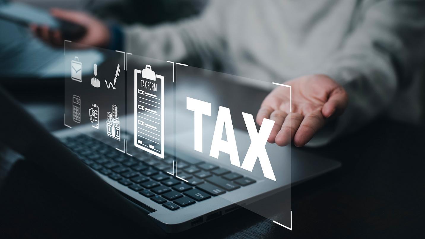 A person typing on a computer, tax benefits with Act 60, puerto rico