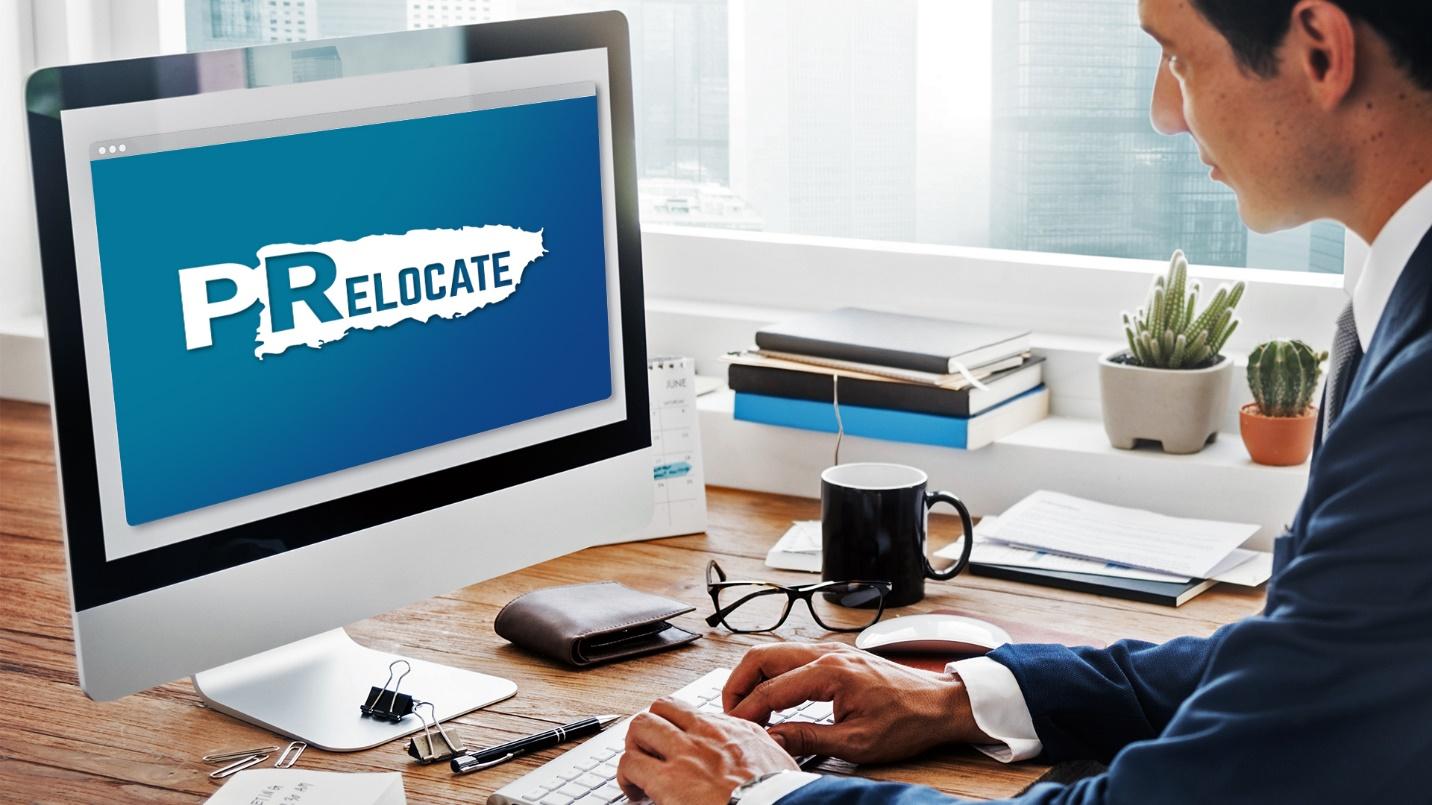 A man in a suit views the PRelocate logo on his computer screen in a section about PRelocate’s real estate services. 
