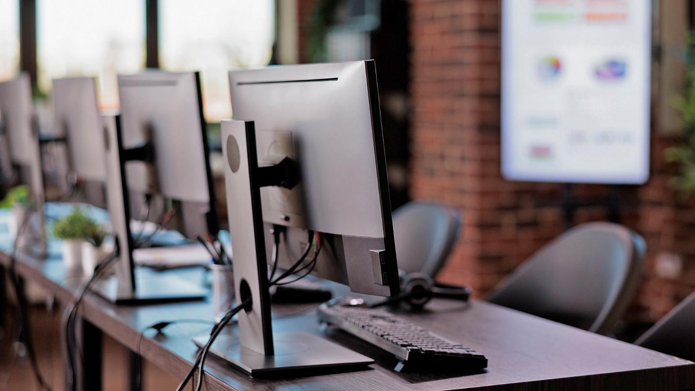 A group of computers on a desk, back office support