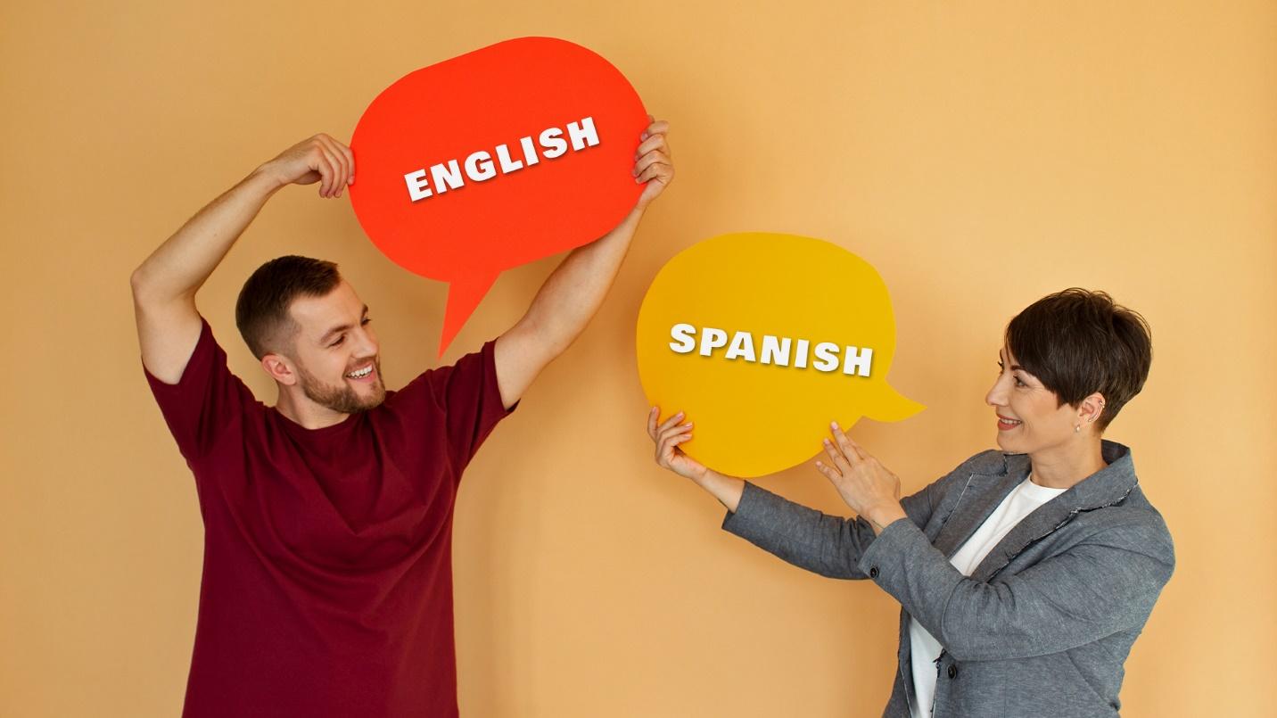A man holds a sign that says “English” and a woman holds a sign that says “Spanish” in a section about Miramar’s languages. 