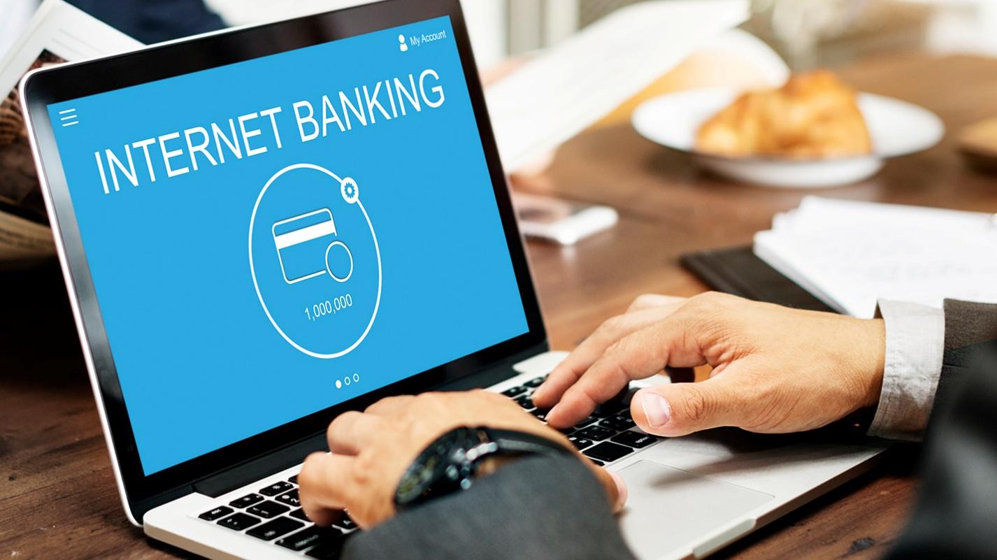 A person working on a computer with the words internet banking on the screen. PRelocate can help you navigate the banking system in puerto rico.