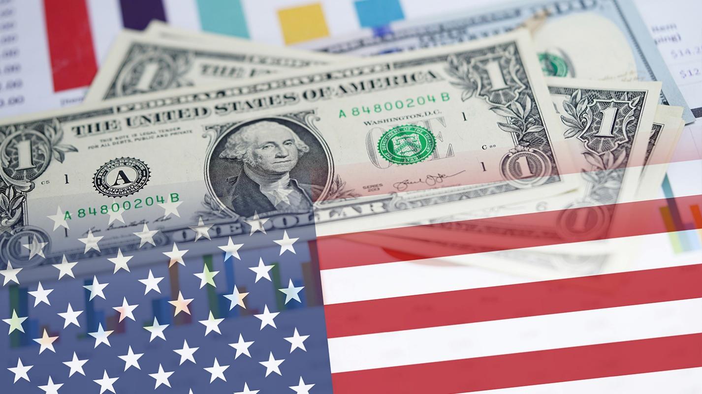 U.S. dollar bills with an overlay of the American flag, symbolizing tax obligations for U.S. citizens living in Puerto Rico.