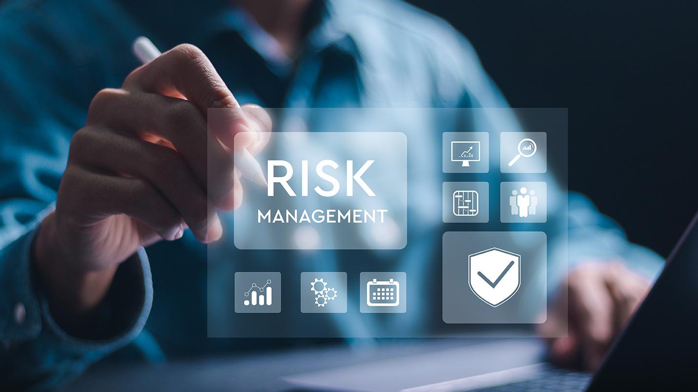 Person using digital interface with the words Risk Management and security icons, representing Act 60 wealth managers in Puerto Rico coordinating compliance and protecting client investments.